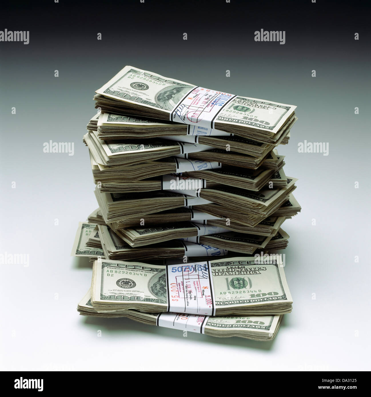 Stacks of wads with 100 US Dollar bills Stock Photo