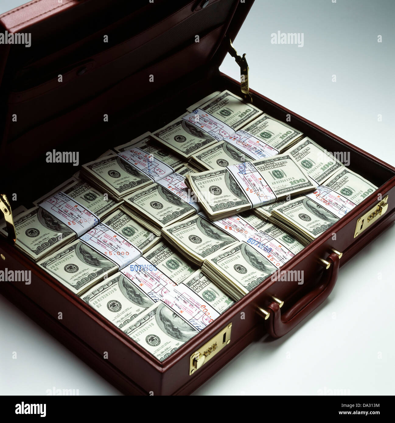 Briefcase with stacks of bundled 100 US Dollar bills Stock Photo
