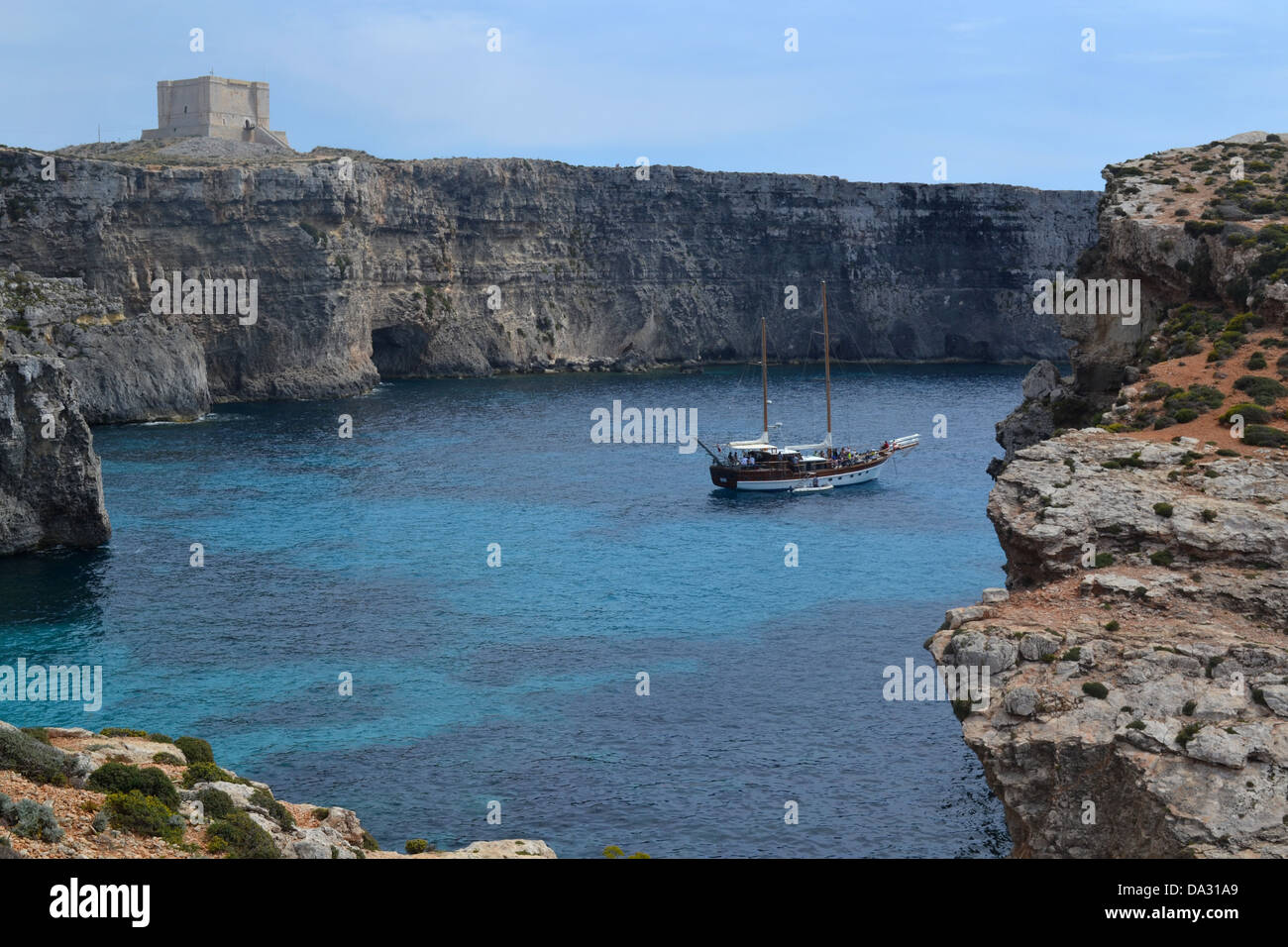 Boat, fort and caves, Comino island, Malta. Stock Photo