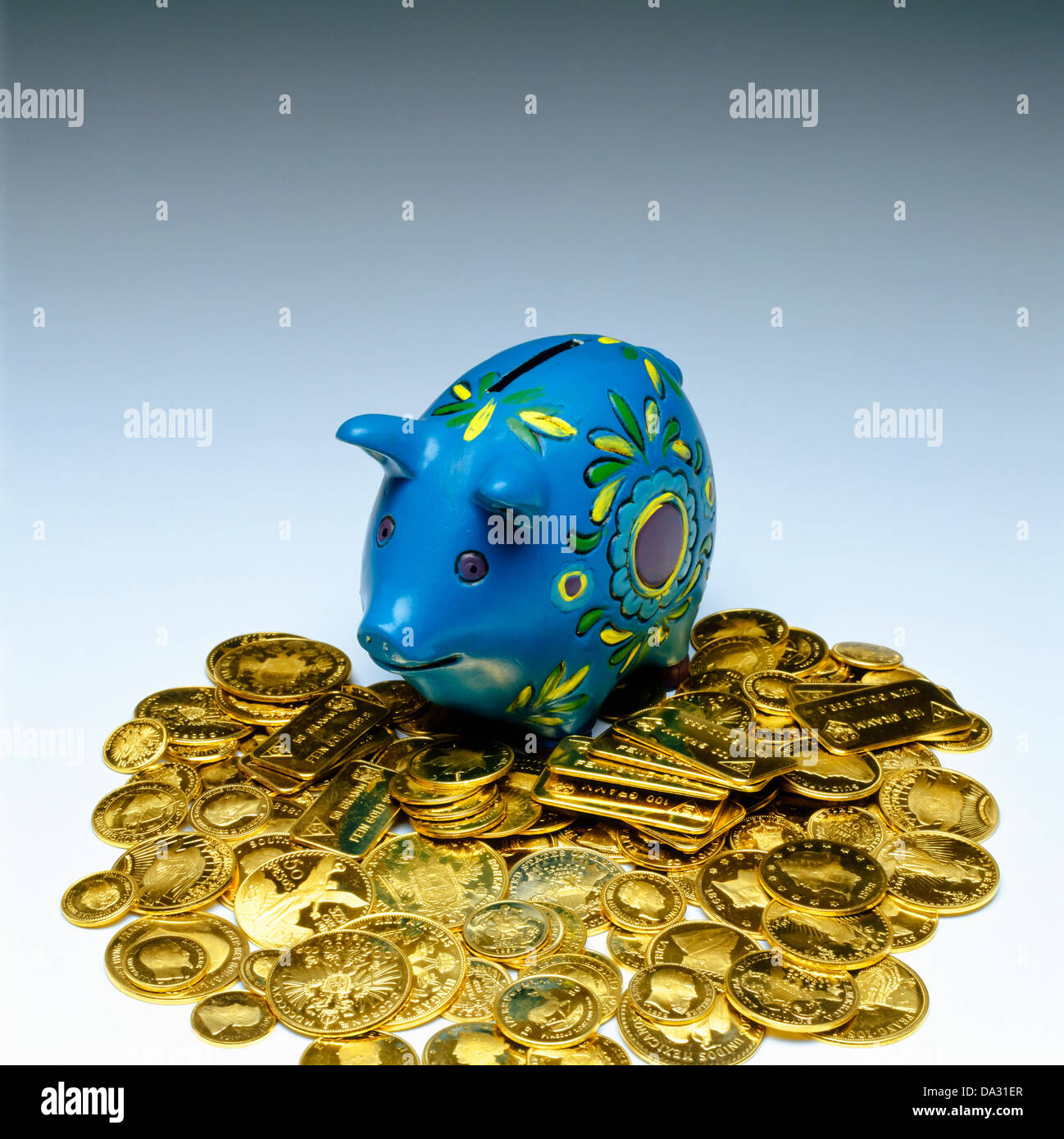 Blue piggy bank with gold coins Stock Photo