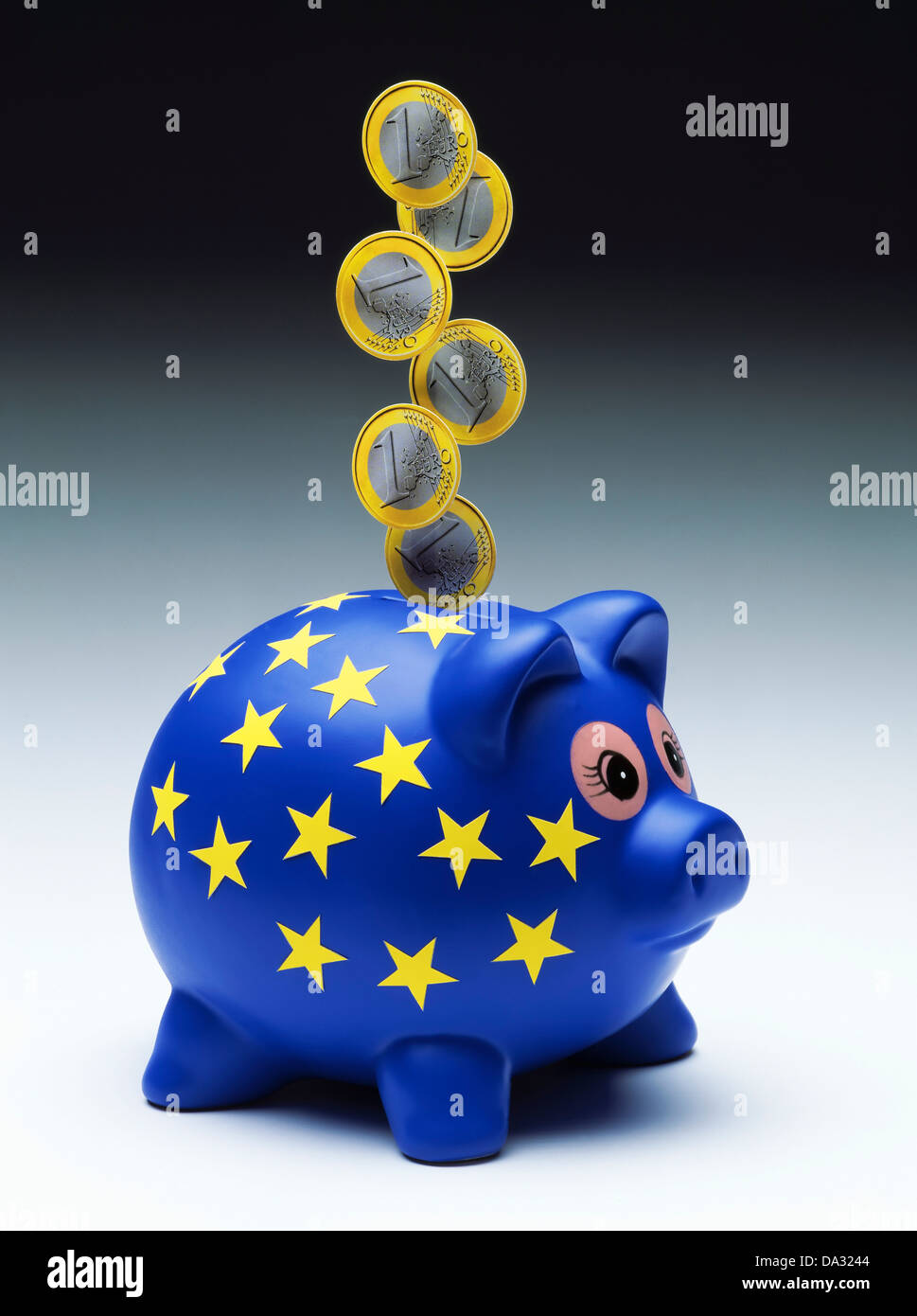 1 Euro coins falling into the slot of an European piggy bank Stock Photo
