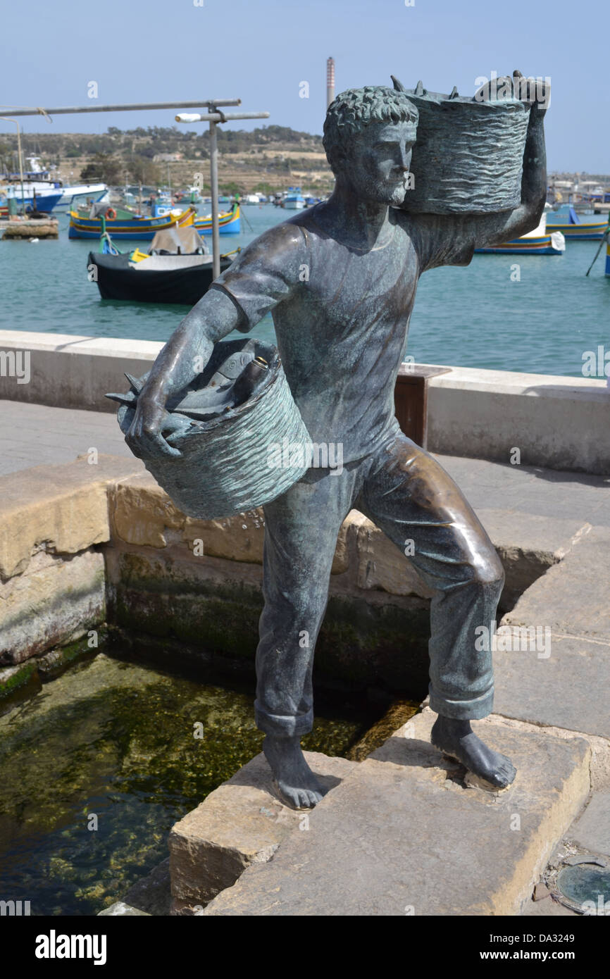 Statue of fisherman, Marsaxlokk fishing village, Malta Stock Photo Alamy