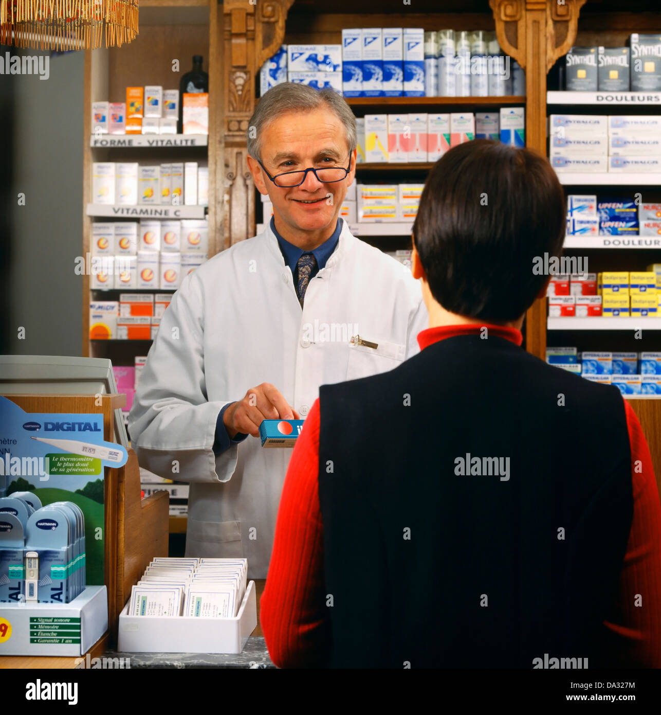 Pharmacist with customer, France Stock Photo