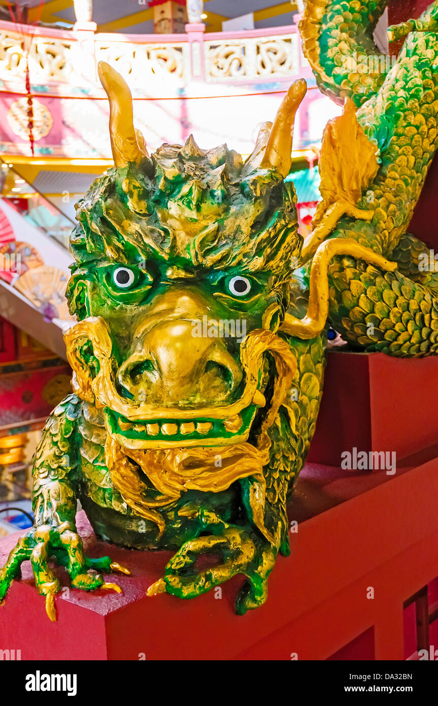 Funny green and gold Chinese dragon sculpture Stock Photo