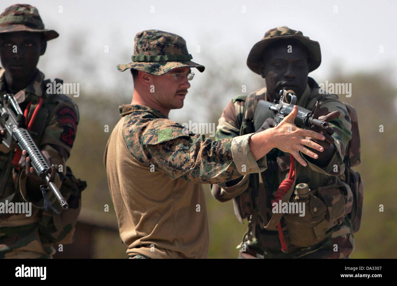 A US Marine instructor teaches a Senegalese Companie de Fusilier Marine Commandos how to fire a M-4 rifle during light infantry training April 22, 2013 in Toubacouta, Senegal, May 9, 2013. Stock Photo