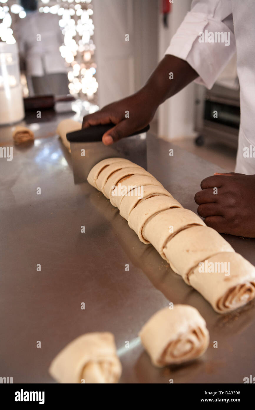 african american women making cinnamon buns from scratch Stock Photo