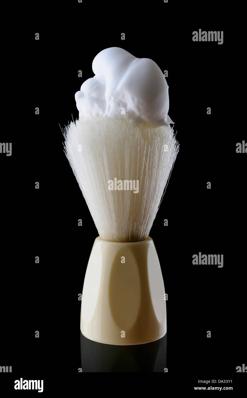 A shaving brush with shaving cream. isolated on black background Stock