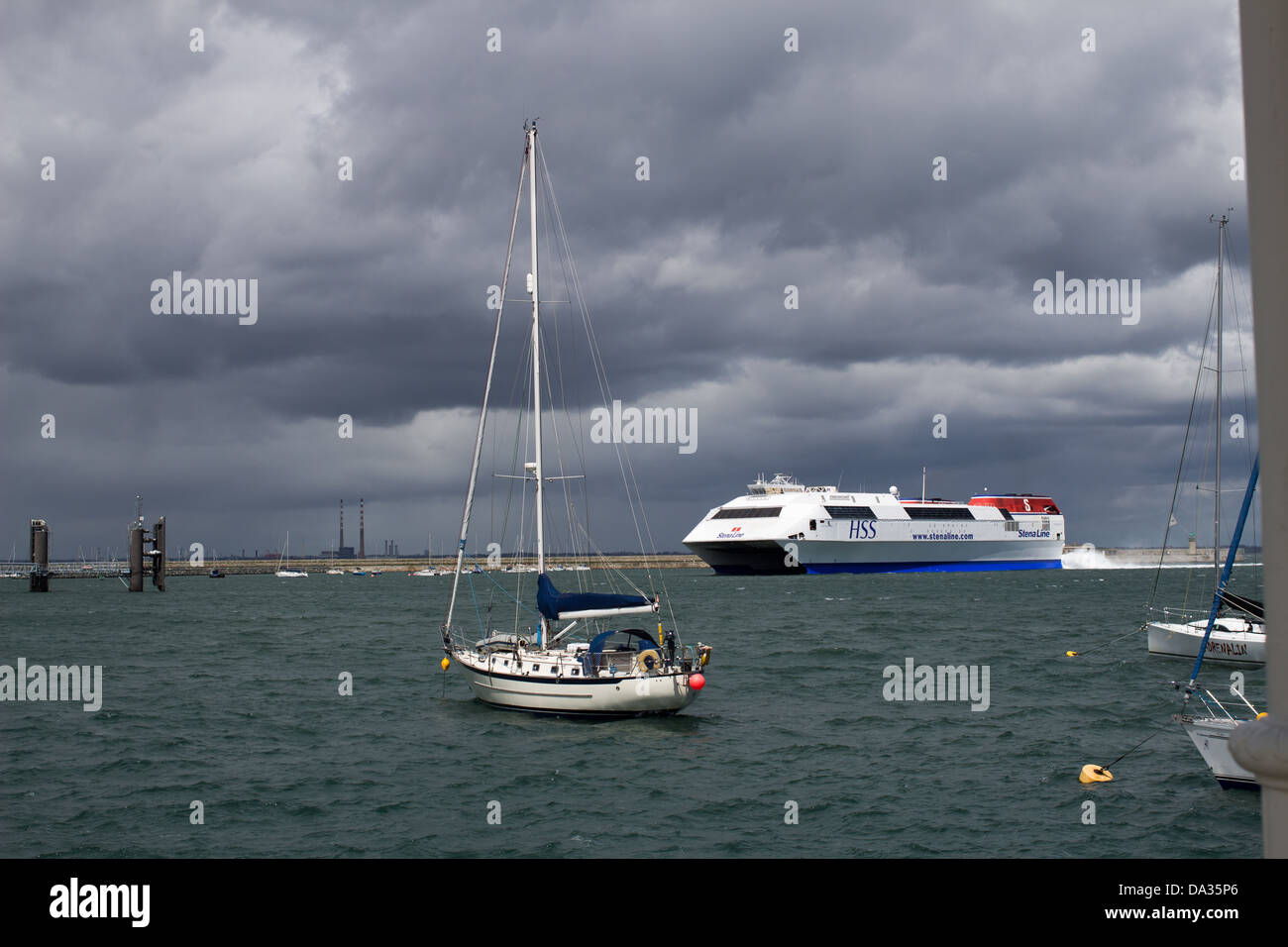 A ferry is about to dock in Dún Laoghaire harbor. Stock Photo