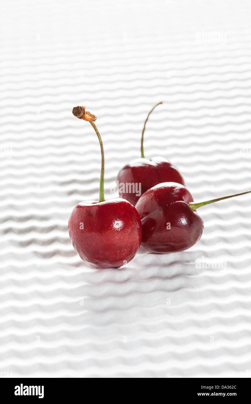 Three Cherries on White Background Stock Photo