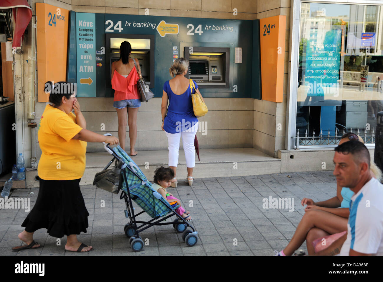 Cyprus, Nicosia. 02nd July, 2013. A woman withdraw money from an Atm of Bank of Cyprus in capital Nicosia on July 2,2013.The Bank of Cyprus on Tuesday approved a voluntary redundancy scheme which will see 1,000 employees taking compensation for early retirement. Credit:  Yiannis Kourtoglou/Alamy Live News Stock Photo