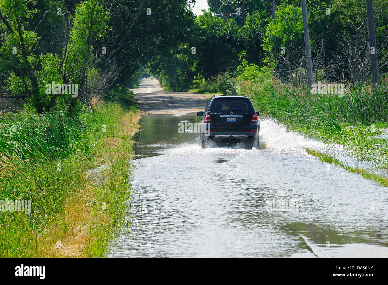 Car crossing flooded section of rural country road Stock Photo - Alamy