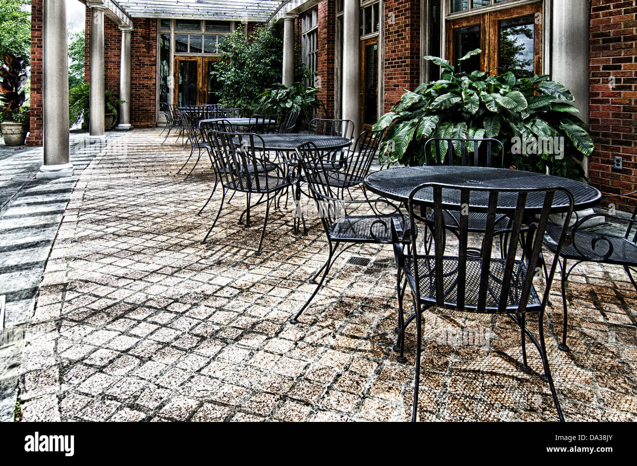 This image is a stone patio with wrought iron tables and chairs at the Alabama Shakespeare Festival in Montgomery, Alabama. Stock Photo