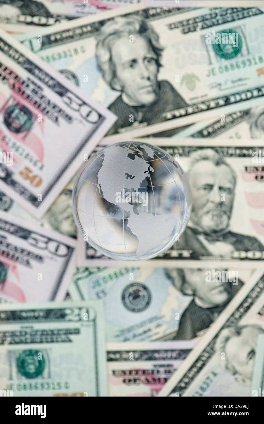 Glass Globe showing America on American dollar bills Stock Photo