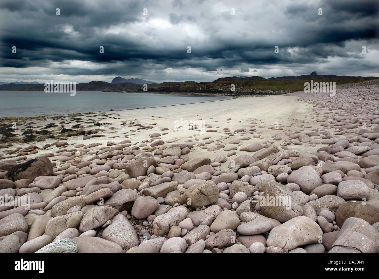Pebbles on Garvie Beach under a dramatic dark sky, Garvie Bay, Enard