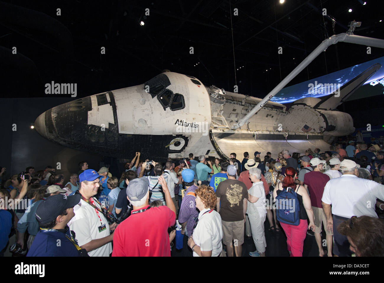 Visitors gather around the new Space Shuttle Atlantis facility at the Kennedy Space Center Visitor Complex June 29, 2013 in Cape Canaveral, Florida. The new $100 million facility includes interactive exhibits that tell the story of the 30-year Space Shuttle Program and highlight the future of space exploration. Stock Photo