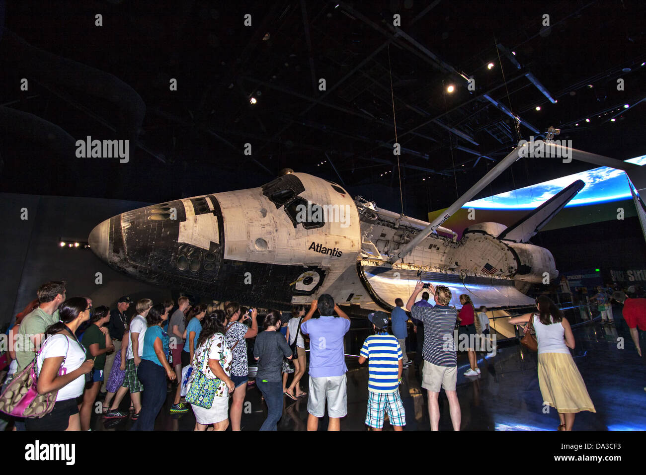 Visitors gather around the new Space Shuttle Atlantis facility at the Kennedy Space Center Visitor Complex June 29, 2013 in Cape Canaveral, Florida. The new $100 million facility includes interactive exhibits that tell the story of the 30-year Space Shuttle Program and highlight the future of space exploration. Stock Photo