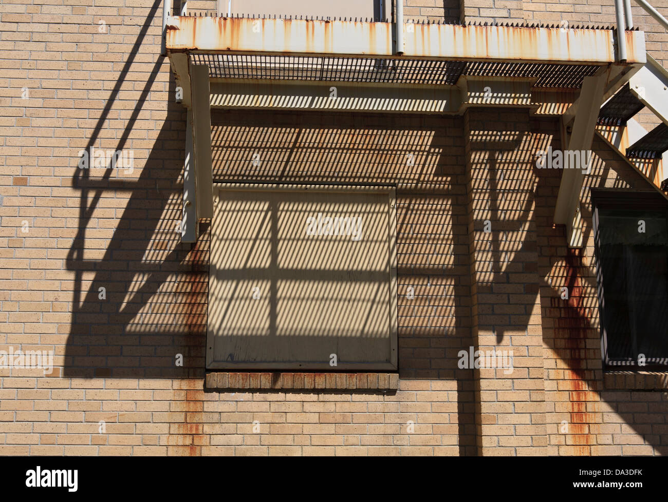 Shadows on a brick wall from a fire escape Stock Photo