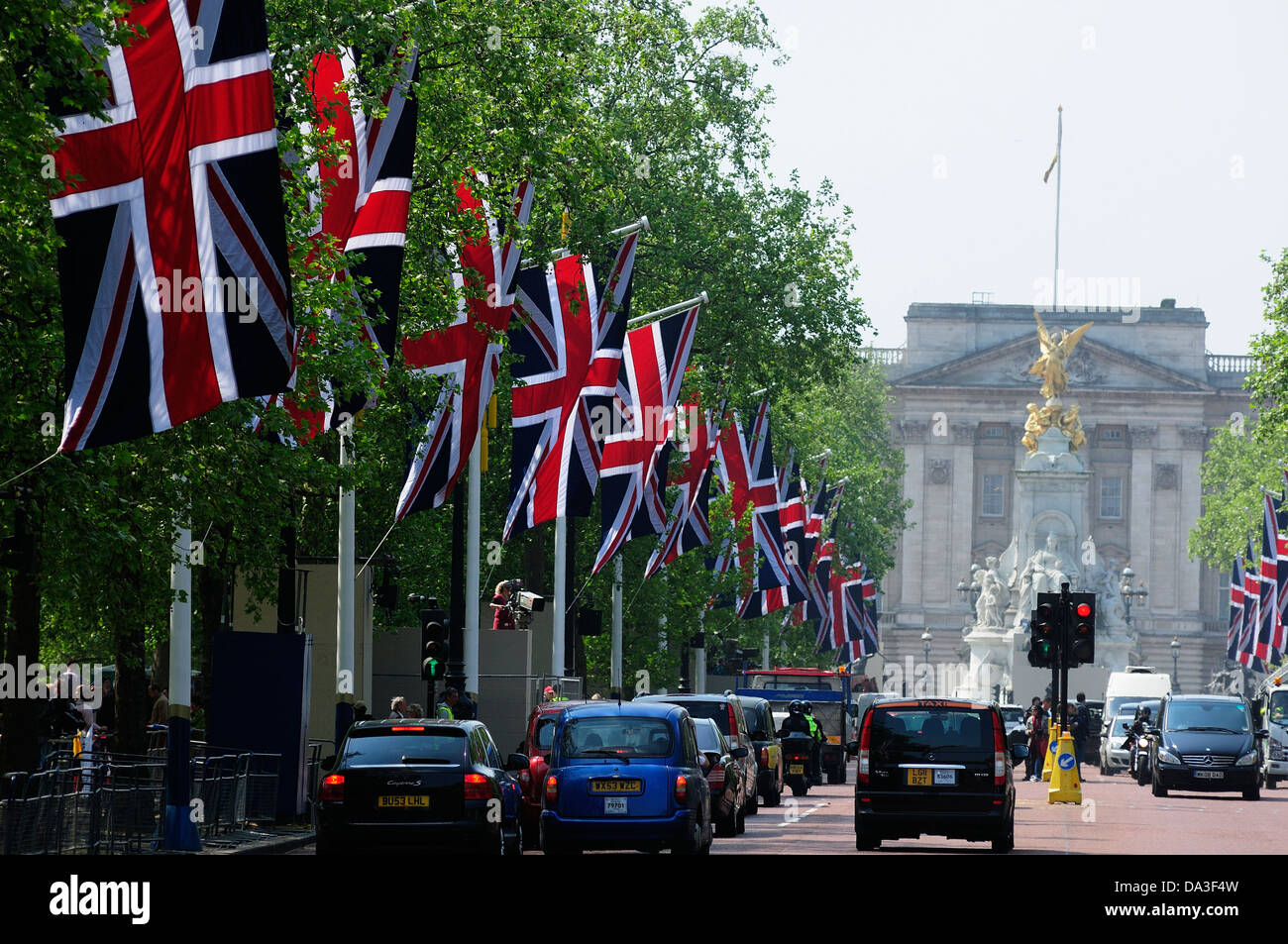 Union Jacks flying in the Mall with Buckingham Palace in the Background