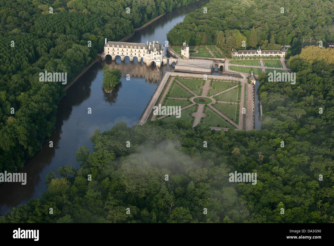 AERIAL VIEW. Chateau of Chenonceau spanning the Cher River, Diane de Poitiers Garden on the left bank. Chenonceaux, Centre-Val de Loire, France. Stock Photo