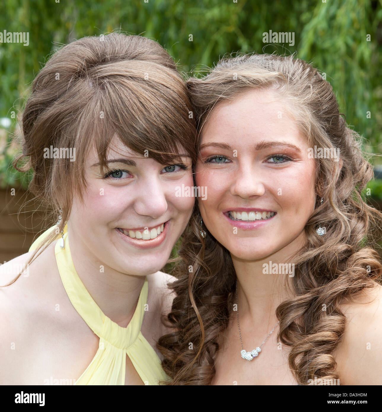 Portrait Of Two Teenage Girls Wearing Party Dresses Stock Photo