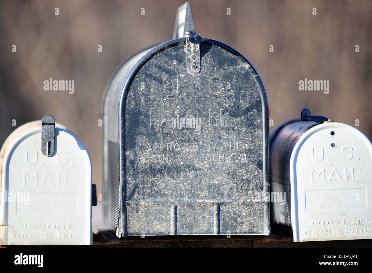 Illinois, USA. Three weathered mailboxes resting on a common platform in rural Illinois. Stock Photo