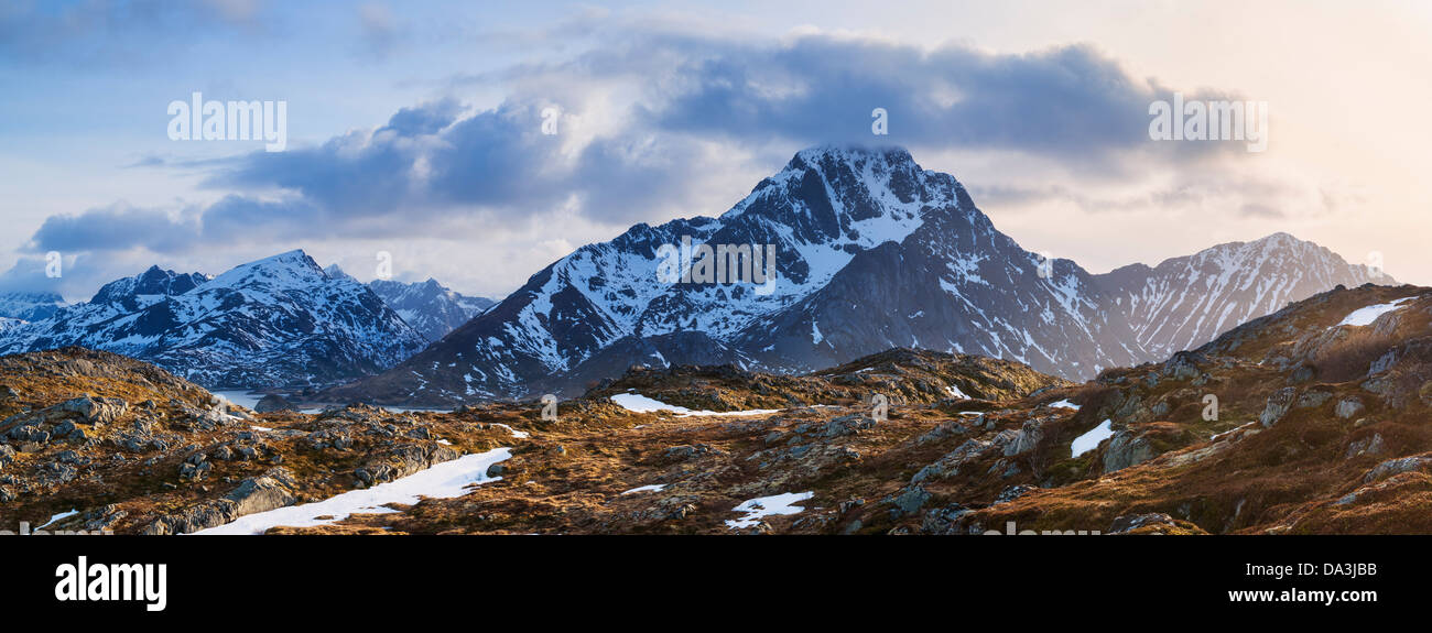 Stornappstind (740m) mountain peak rises above dramatic landscape, viewed from Offersoykammen, Lofoten Islands, Norway Stock Photo