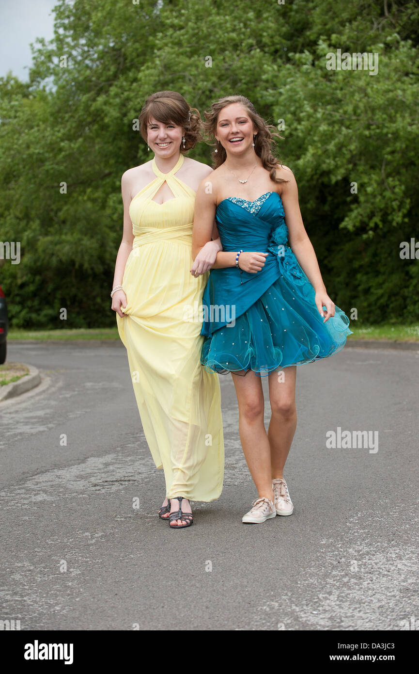 Teenage girls in party dresses walking along a street, Going to party at  end of term prom Stock Photo - Alamy