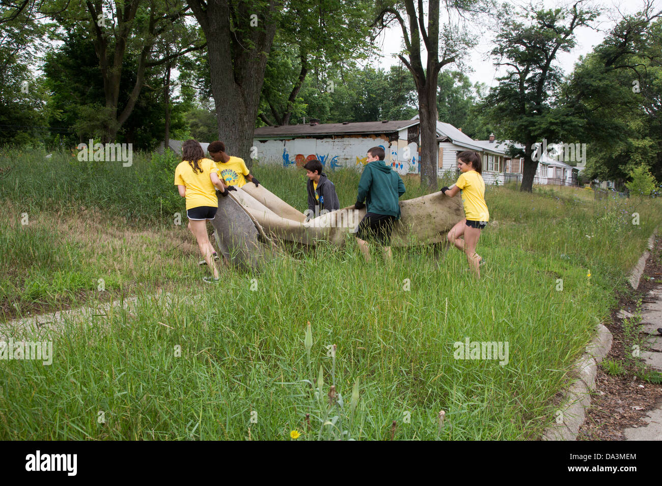High school volunteers clean trash and debris in Brightmoor, one of the most distressed neighborhoods of Detroit. Stock Photo