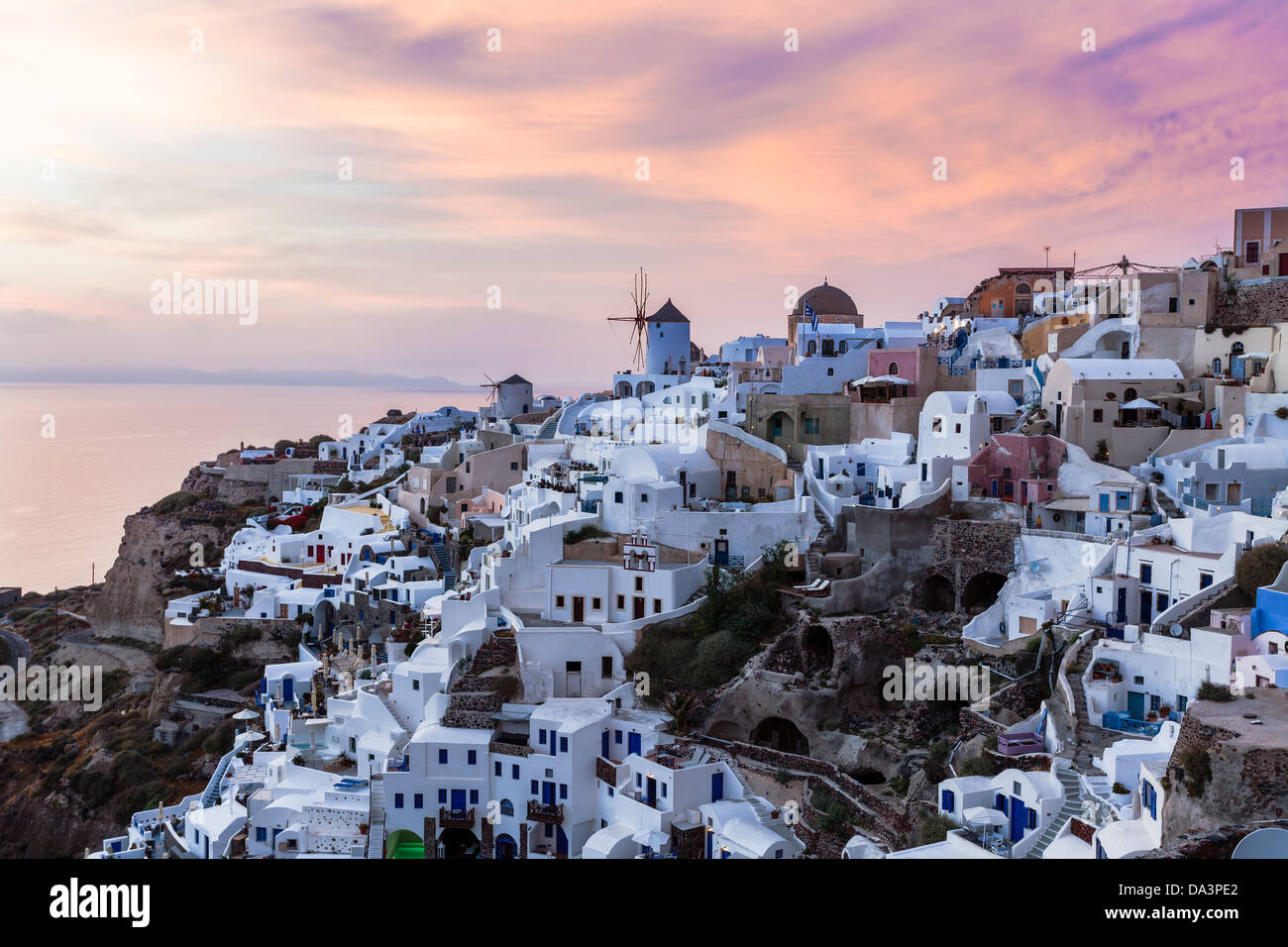 Vibrant sunset over houses and villas at Oia Santorini Greece Stock Photo
