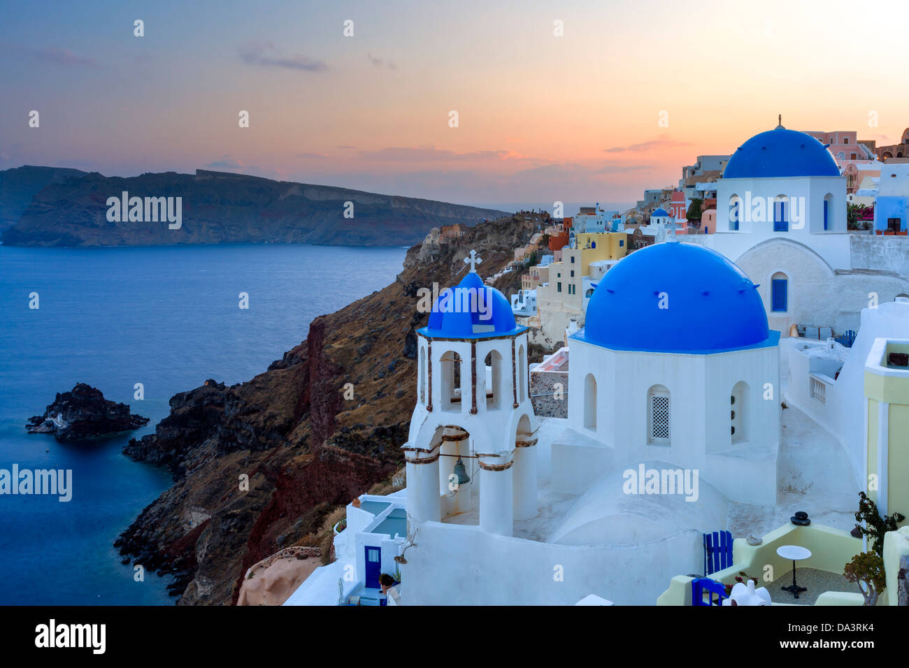 Dusk over blue domed churches at Oia Santorini Greece Stock Photo