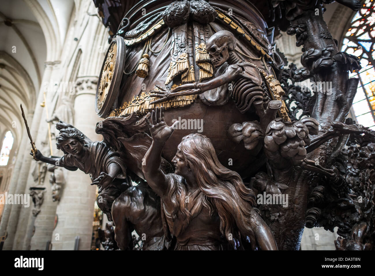 BRUSSELS, Belgium — Part of the ornately carved wooden pulpit at the Cathedral of St. Michael and St. Gudula (in French, Co-Cathédrale collégiale des Ss-Michel et Gudule). A church was founded on this site in the 11th century but the current building dates to the 13th to 15th centuries. The Roman Catholic cathedral is the venue for many state functions such as coronations, royal weddings, and state funerals. It has two patron saints, St Michael and St Gudula, both of whom are also the patron saints of Brussels. Stock Photo