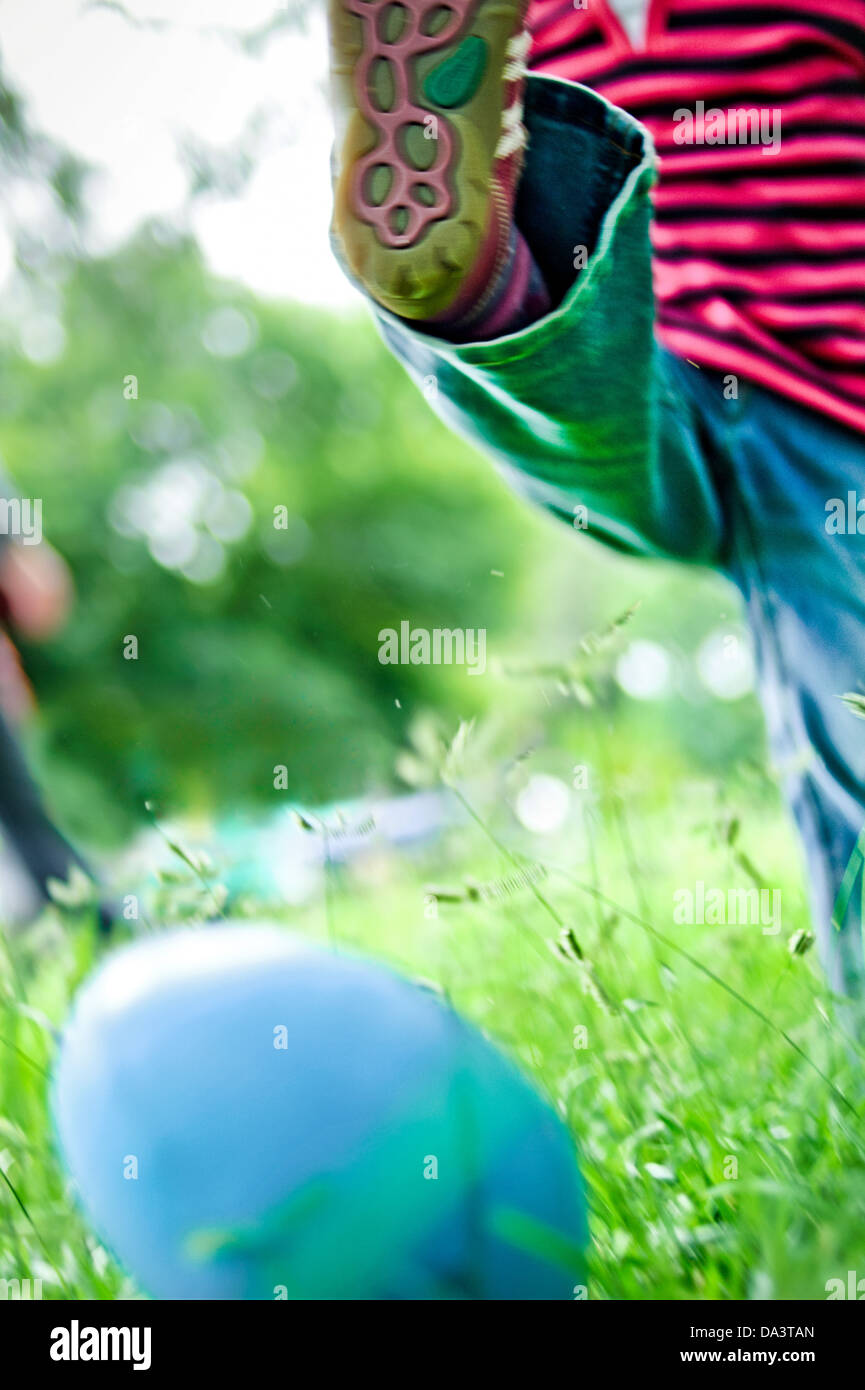 Toddler kicking football Stock Photo Alamy