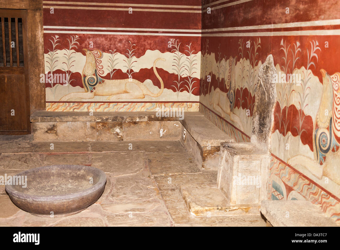 Wall frescoes of griffins and alabaster throne in the Throne room, Knossos Palace, Knossos, Crete, Greece Stock Photo
