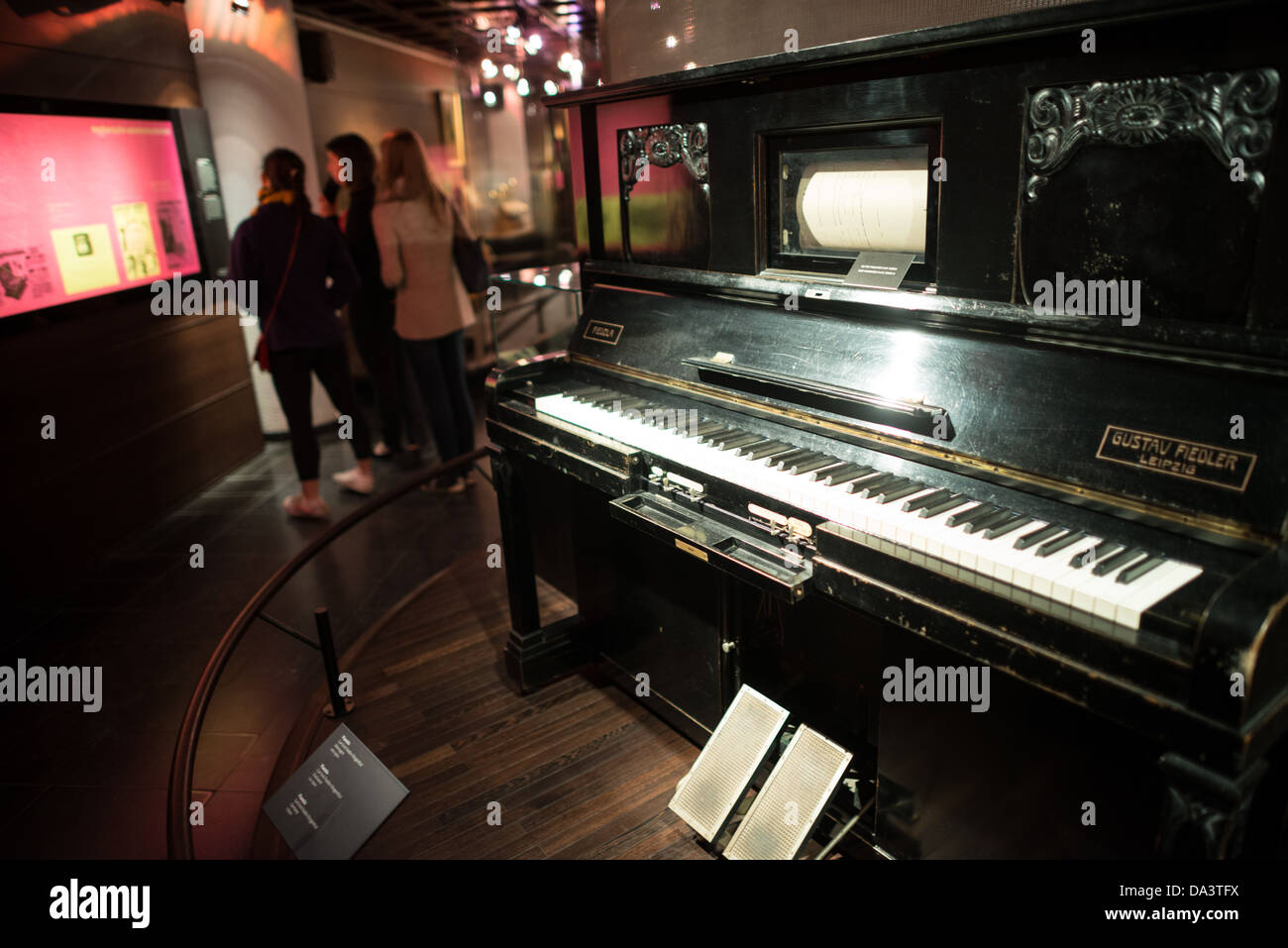 BRUSSELS, Belgium - A pianolo built in 1900 on display a the Musical Instrument Museum in Brussels. The Musee des Instruments de Musique (Musical Instrument Museum) in Brussels contains exhibits containing more than 2000 musical instruments. Displays include historical, exotic, and traditional cultural instruments from around the world. Visitors to the museum are given handheld audio guides that play musical demonstrations of many of the instruments. The museum is housed in the distinctive Old England Building. Stock Photo