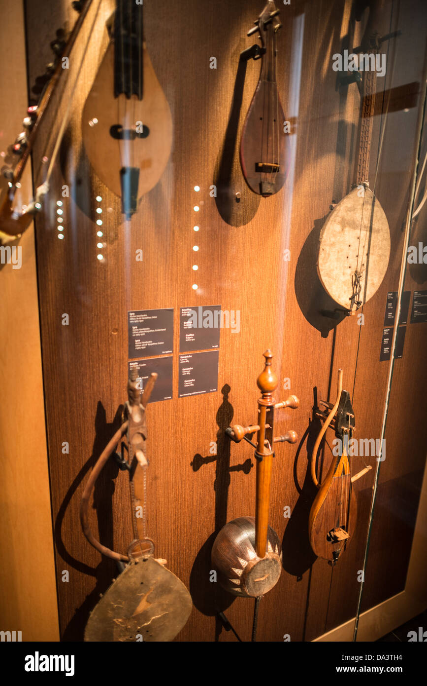 BRUSSELS, Belgium - Various stringed instruments on display at the Musical Instrument Museum in Brussels, including a Bulgarian Gouslitsa (1912)  (top center), and Kamantcha from the Caucases (1883) (bottom middle), and a Gousla. The Musee des Instruments de Musique (Musical Instrument Museum) in Brussels contains exhibits containing more than 2000 musical instruments. Displays include historical, exotic, and traditional cultural instruments from around the world. Visitors to the museum are given handheld audio guides that play musical demonstrations of many of the instruments. The museum is h Stock Photo