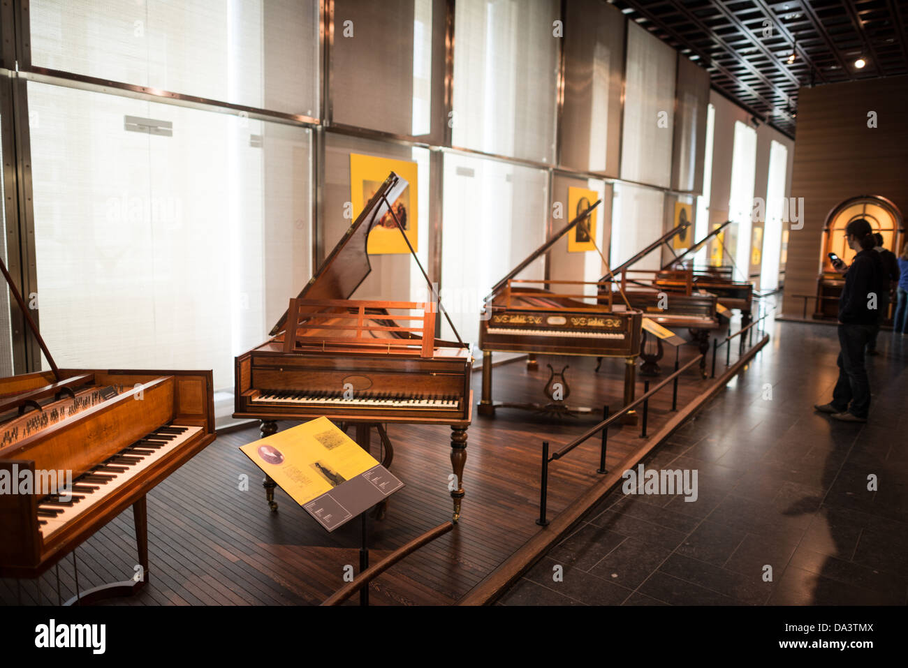 BRUSSELS, Belgium - Pianos on display at the Musical Instrument Museum in Brussels. The Musee des Instruments de Musique (Musical Instrument Museum) in Brussels contains exhibits containing more than 2000 musical instruments. Displays include historical, exotic, and traditional cultural instruments from around the world. Visitors to the museum are given handheld audio guides that play musical demonstrations of many of the instruments. The museum is housed in the distinctive Old England Building. Stock Photo