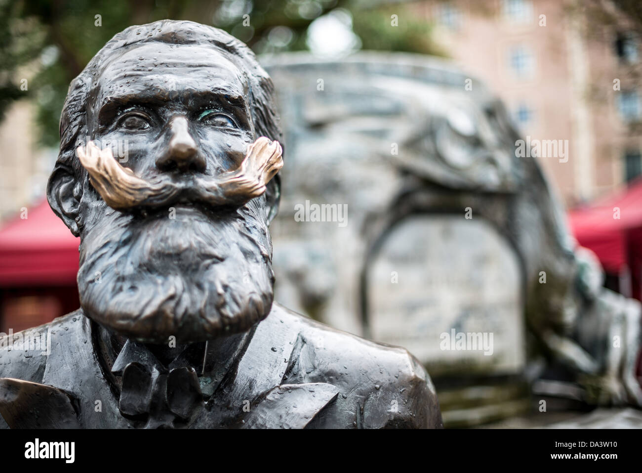 BRUSSELS, Belgium - A statue of Karel Buls (Charles Buls), a former mayor of the City of Brussels (from 1881 to 1899). The statue sits in Grasmarkt/Rue du Marché aux Herbes-Agora Square in the city's Lower Town. Stock Photo