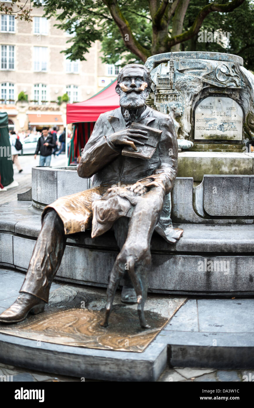 BRUSSELS, Belgium - A statue of Karel Buls (Charles Buls), a former mayor of the City of Brussels (from 1881 to 1899). The statue sits in Grasmarkt/Rue du Marché aux Herbes-Agora Square in the city's Lower Town. Stock Photo