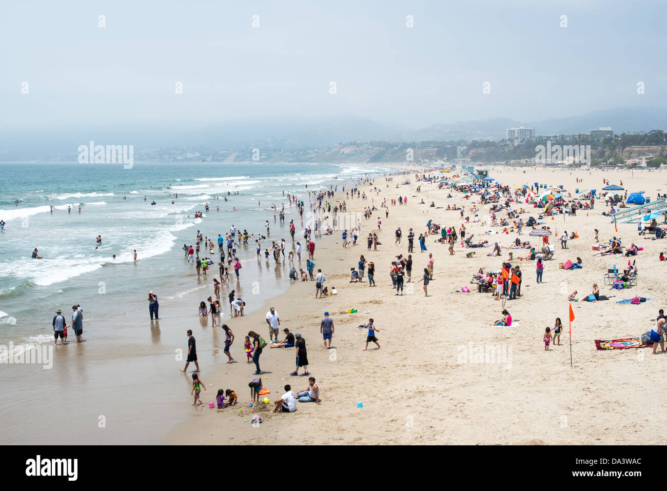 People enjoy the warm summer weather at Santa Monica beach in west Los Angeles, California. Stock Photo