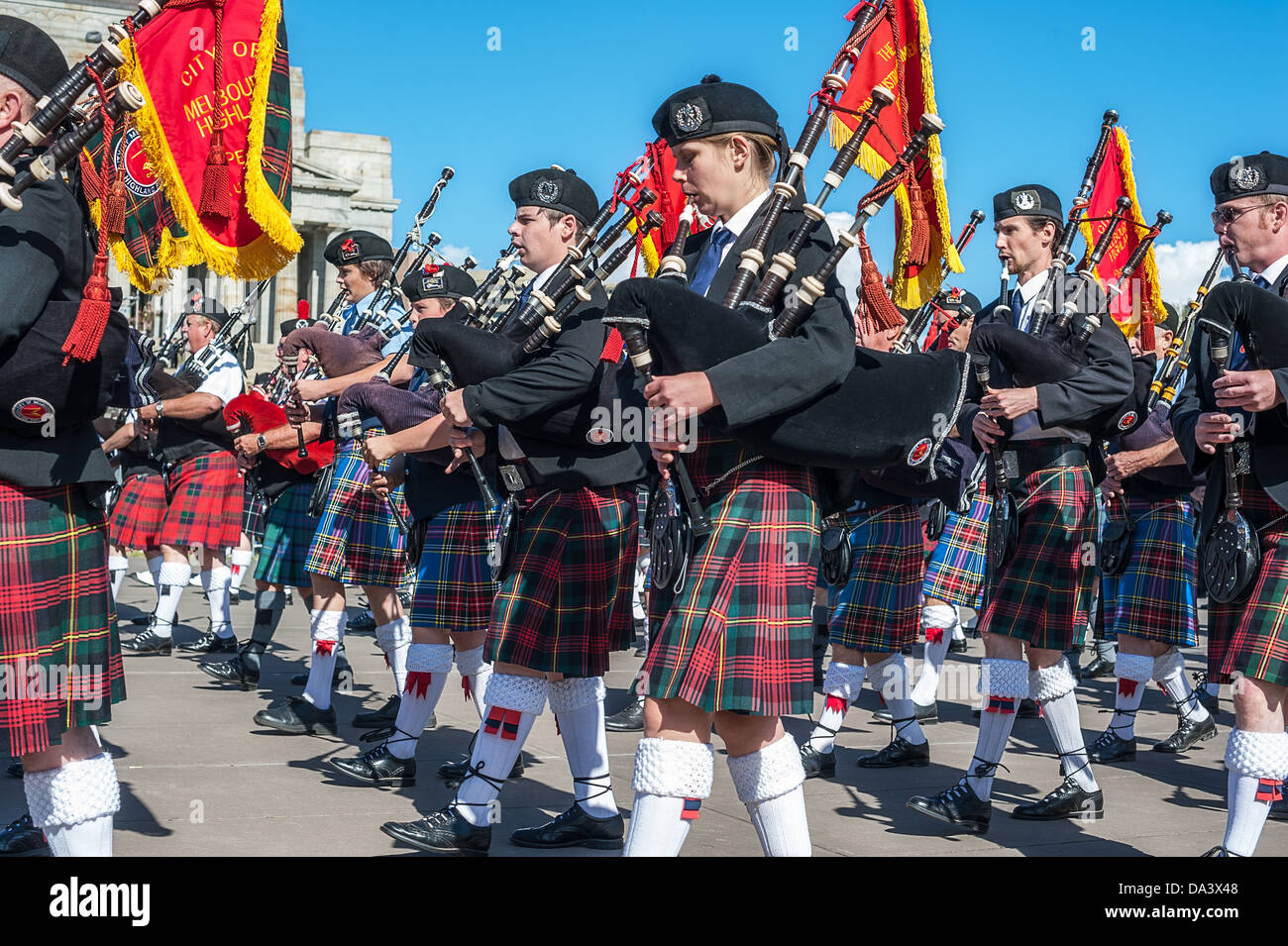 Military brass bands play as thousands attend Anzac Day marches across