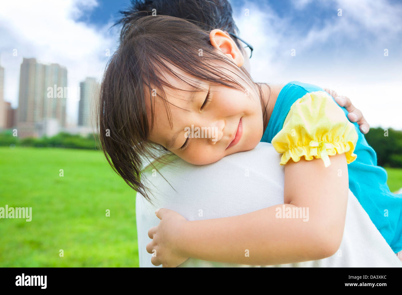 smiling little girl sleeping on his father shoulder Stock Photo