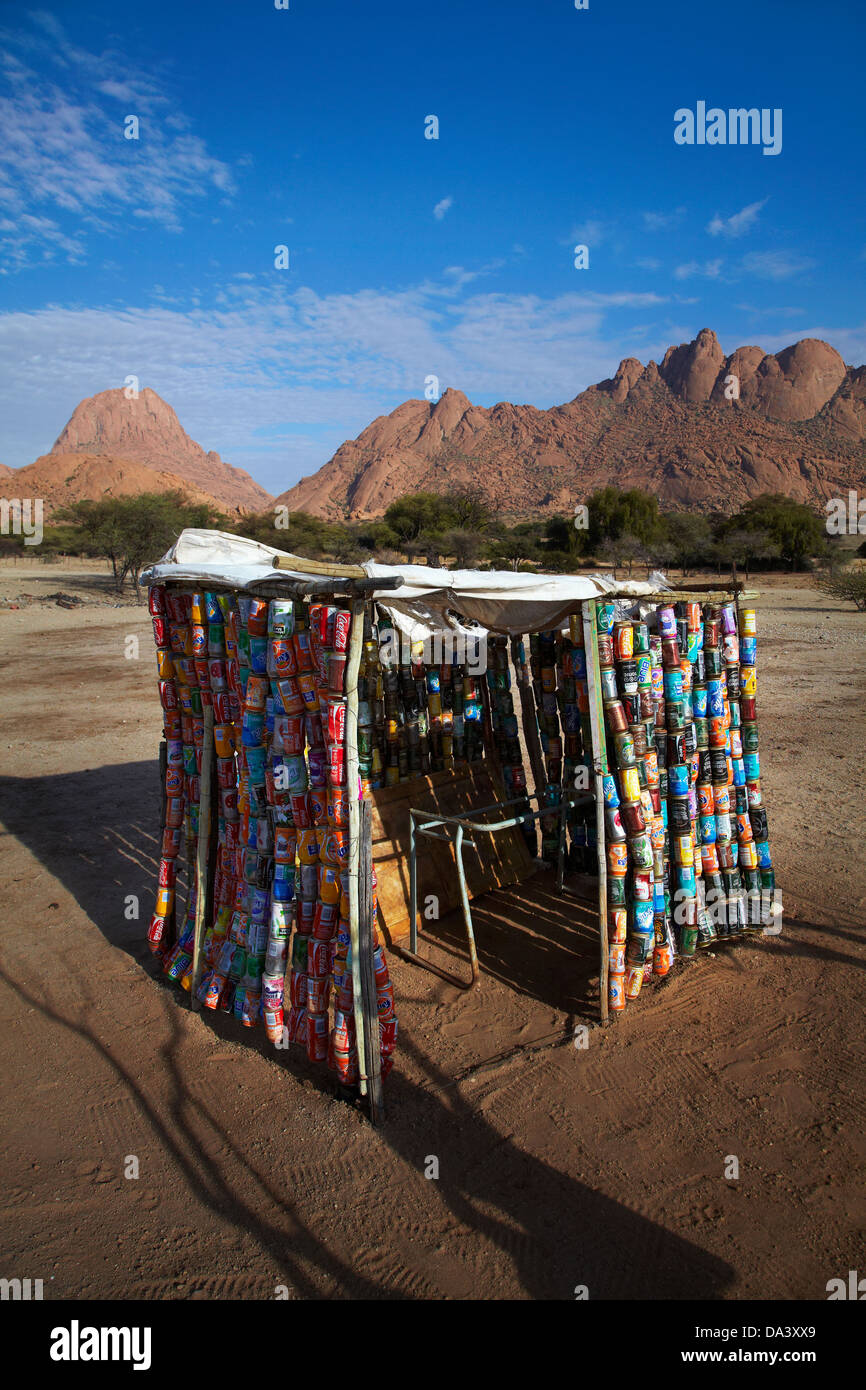 Shed made out of recycled drink cans, Spitzkoppe, and Pondok Mountains (right), Namibia, Africa Stock Photo