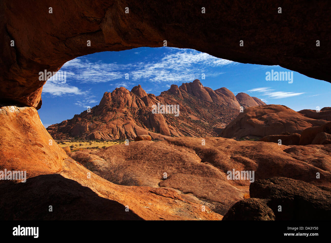 Natural rock arch at Spitzkoppe, and Pondok Mountains in distance, Namibia, Africa Stock Photo