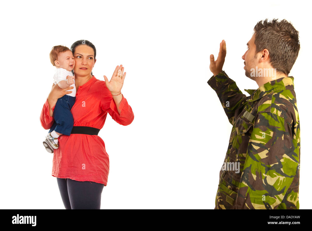 Mother holding crying baby and say goodbye to her military husband which goes back to the army isolated on white background Stock Photo