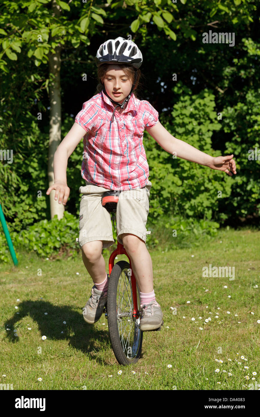 young girl on a unicycle Stock Photo Alamy