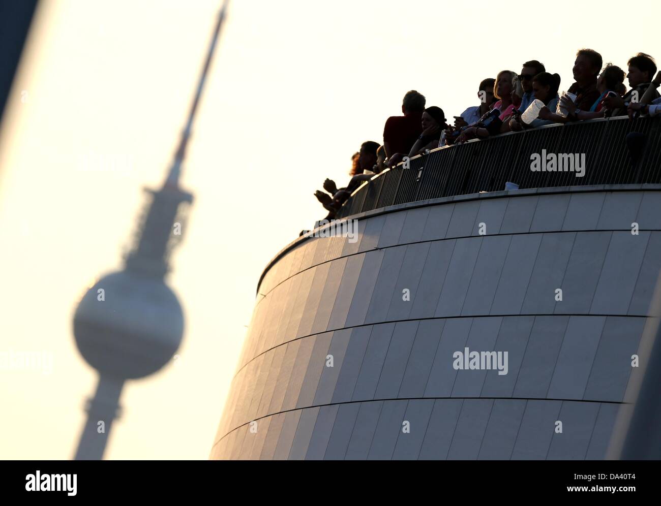 Visitors of the O2-World watch the sunset from a roof terrace before ...