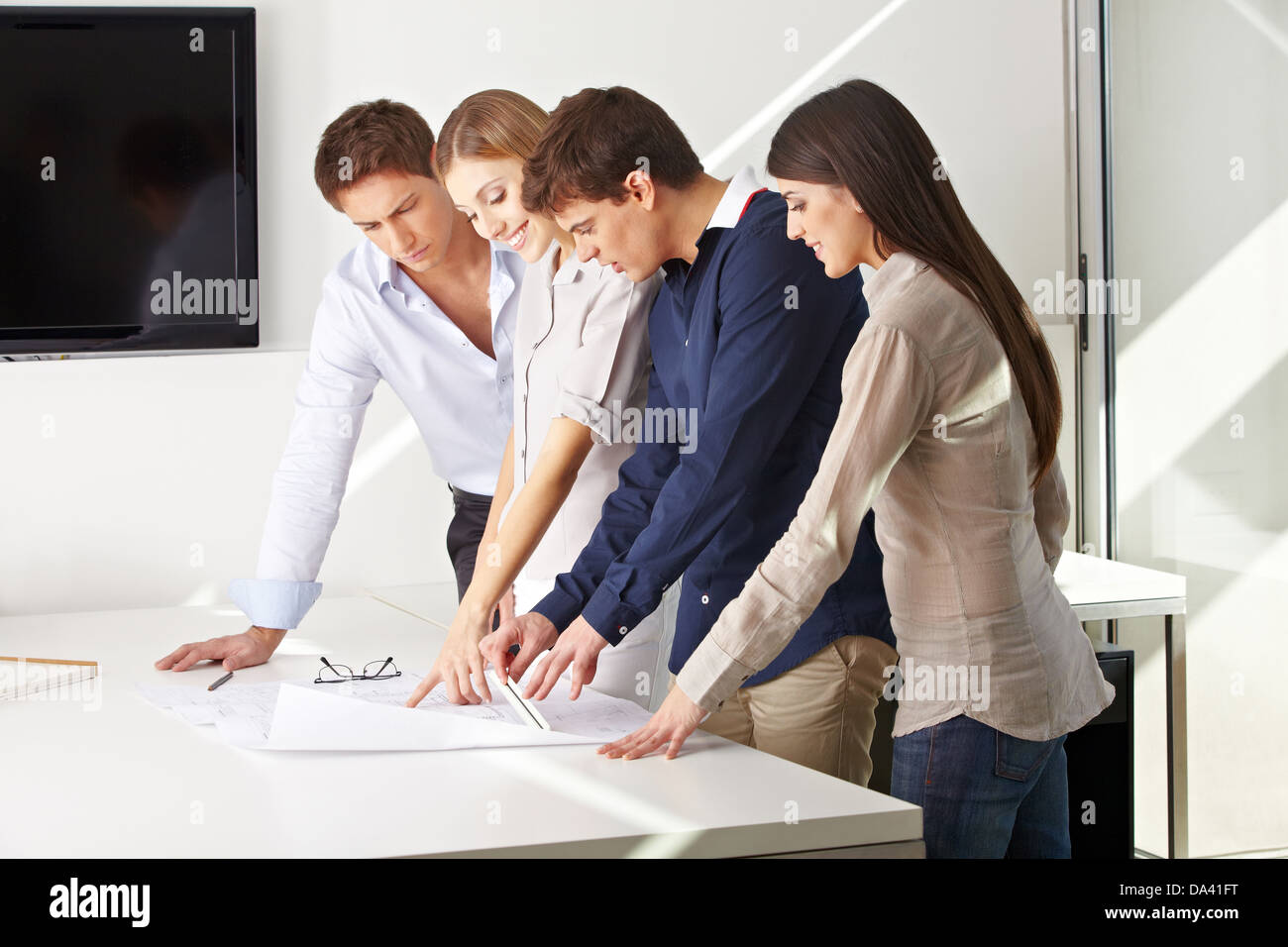 Team of architects working together on building plan in an office Stock Photo