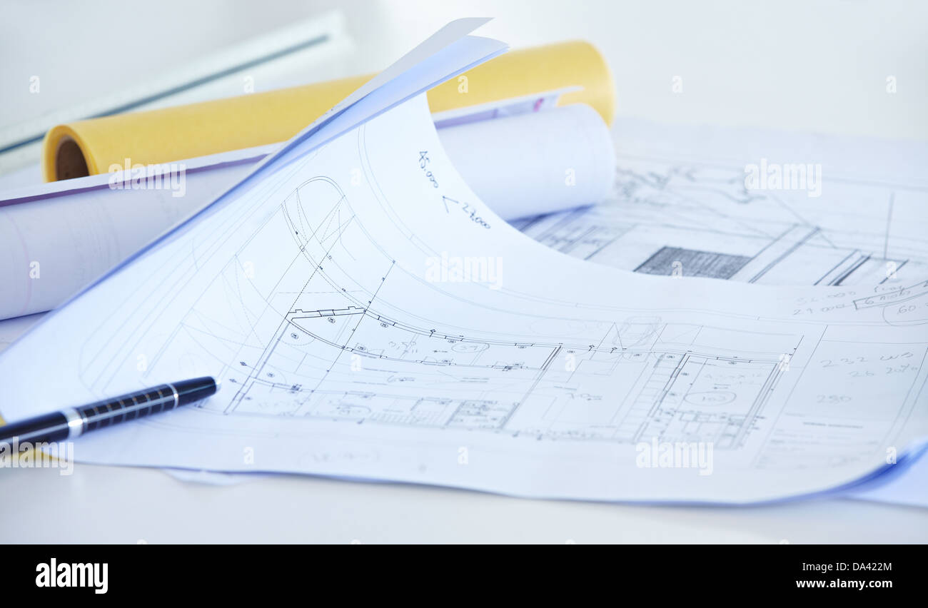 Different architectural drawings with pen on desk in office Stock Photo