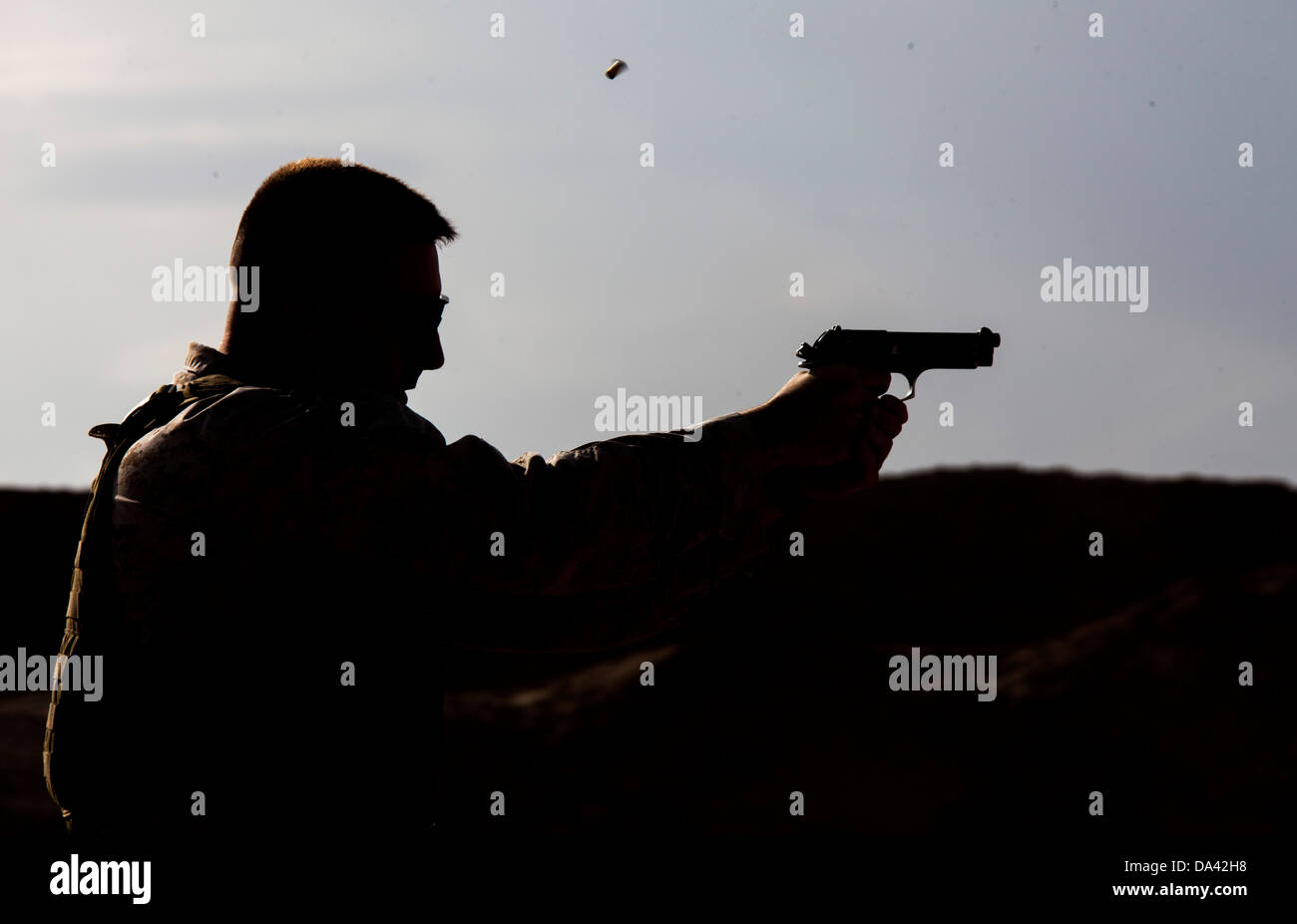 U.S. Marine Corps Staff Sgt. Jeremy Masters from Little Rock, Ark., and assigned to Regimental Combat Team 7 engages his target Stock Photo