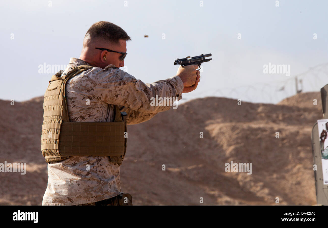U.S. Marine Corps Staff Sgt. Jeremy Masters from Little Rock, Ark., and assigned to Regimental Combat Team 7 engages his target Stock Photo